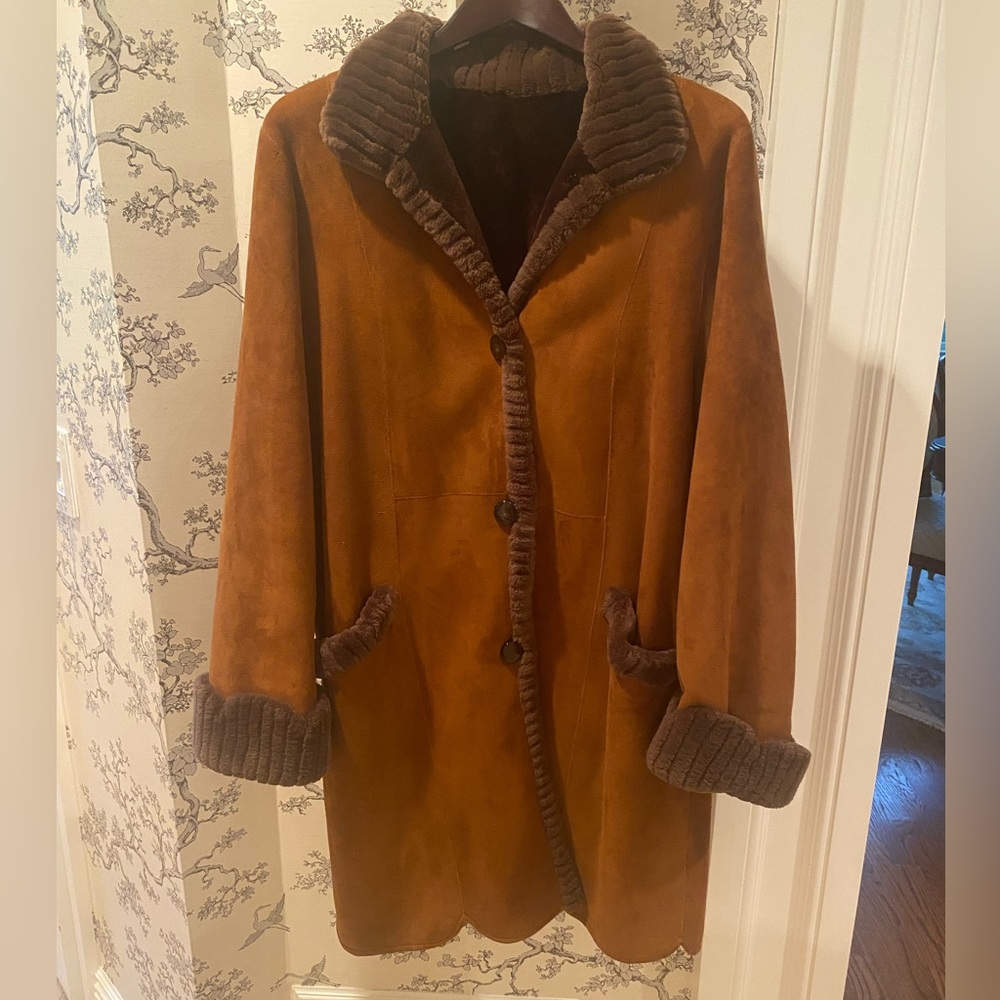 Womens suede and shearling knee length coat. Two pockets cuffs and 3 buttons.